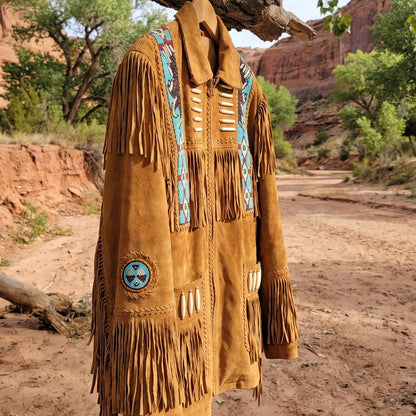 Fringe jacket hanging from a cottonwood branch by a desert river